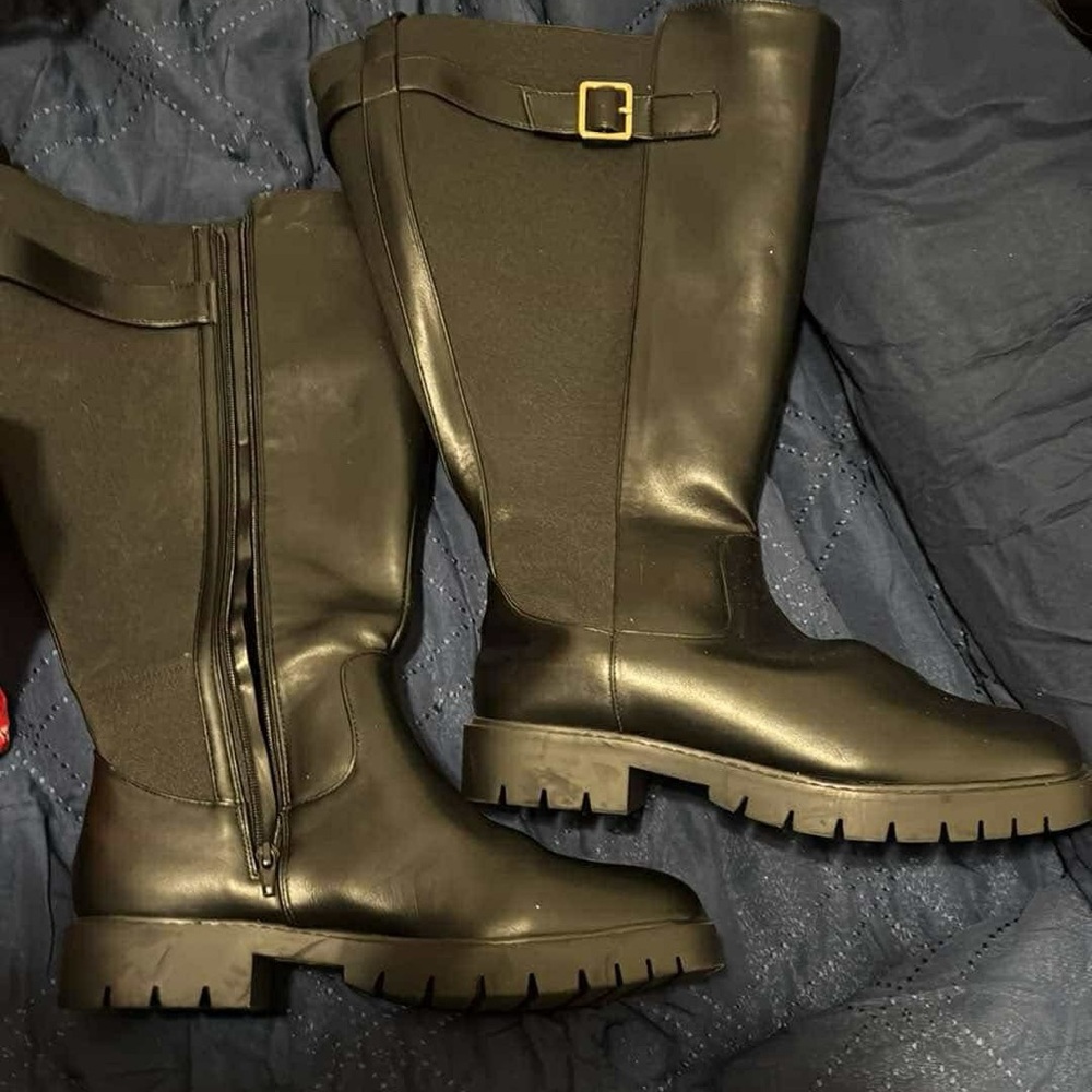 Wide calf black leather riding boots. New with tags and side zipper. Never worn